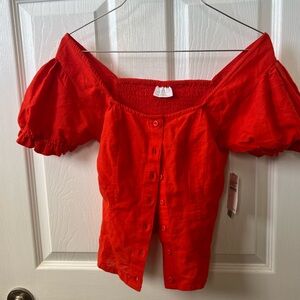 Very cute reddish/orange top for young women. New with tags